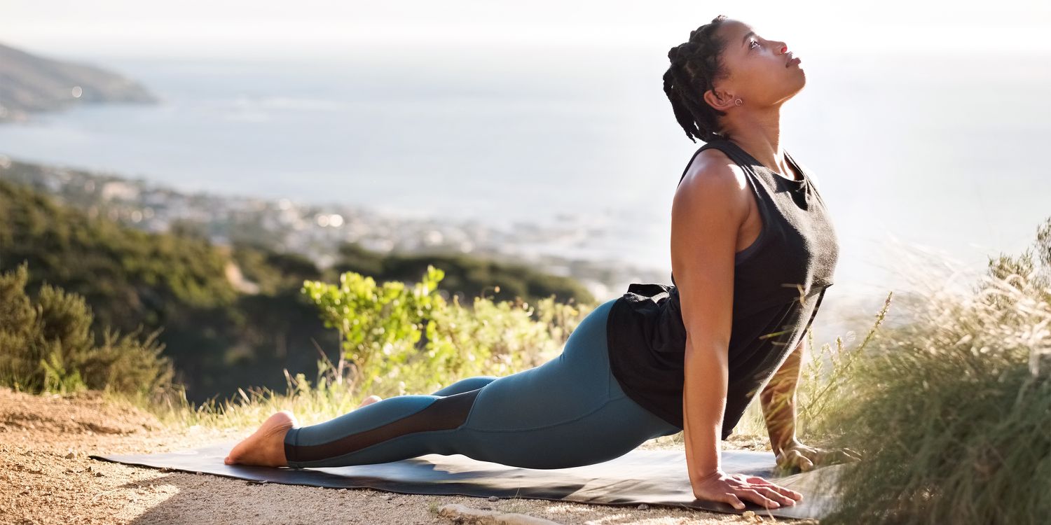 Person stretching outdoors in the morning sunlight, starting a day with intentional movement and energy